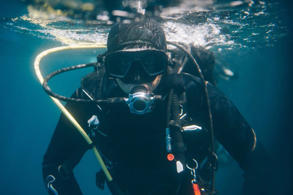 A diver taking on the chananaab reef cozumel, palancar caves cozumel, and devil's throat cozumel.